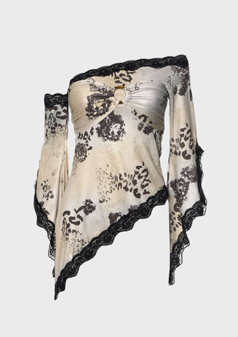 A beige and white floral lace detail top with long sleeves and a round neckline, presented on a mannequin.